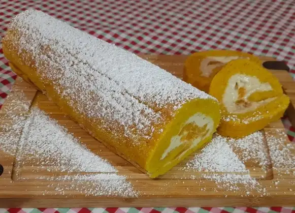 Biskuitrolle mit Karamellcreme und frischen Mandarinenfilets gefüllt