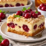 Kirschkuchen mit Streusel und Vanillepudding auf einem Teller