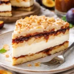 Baiser-Torte mit Vanillecreme und Pflaumenmus auf einem eleganten Dessertteller