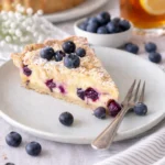 Blaubeer-Tarte mit Vanille-Schmand und Streuseln auf einem Teller