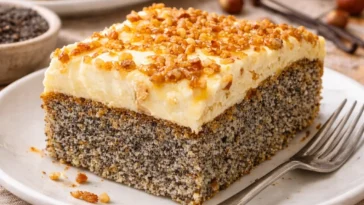 Mohnkuchen ohne Boden mit Paradiescreme und Haselnusskrokant auf einem Teller