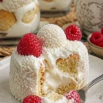 Raffaello-Dessert mit Windbeuteln und Himbeeren auf einem eleganten Teller