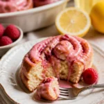 Fruchtige Zimtschnecken mit Zitrone und Himbeeren auf einem Teller