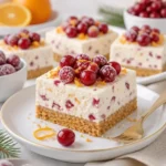 No-Bake Cranberry-Orange-Cheesecake-Riegel auf einem Teller serviert