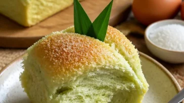 Scheibe frisches Pandanbrot mit grünem Pandan Geschmack auf einer Holzplatte